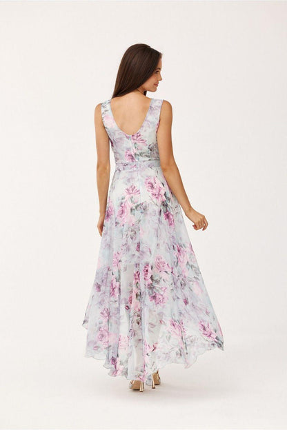 Back of cocktail dress in white with pink floral print, V-shaped back and asymmetrical hem