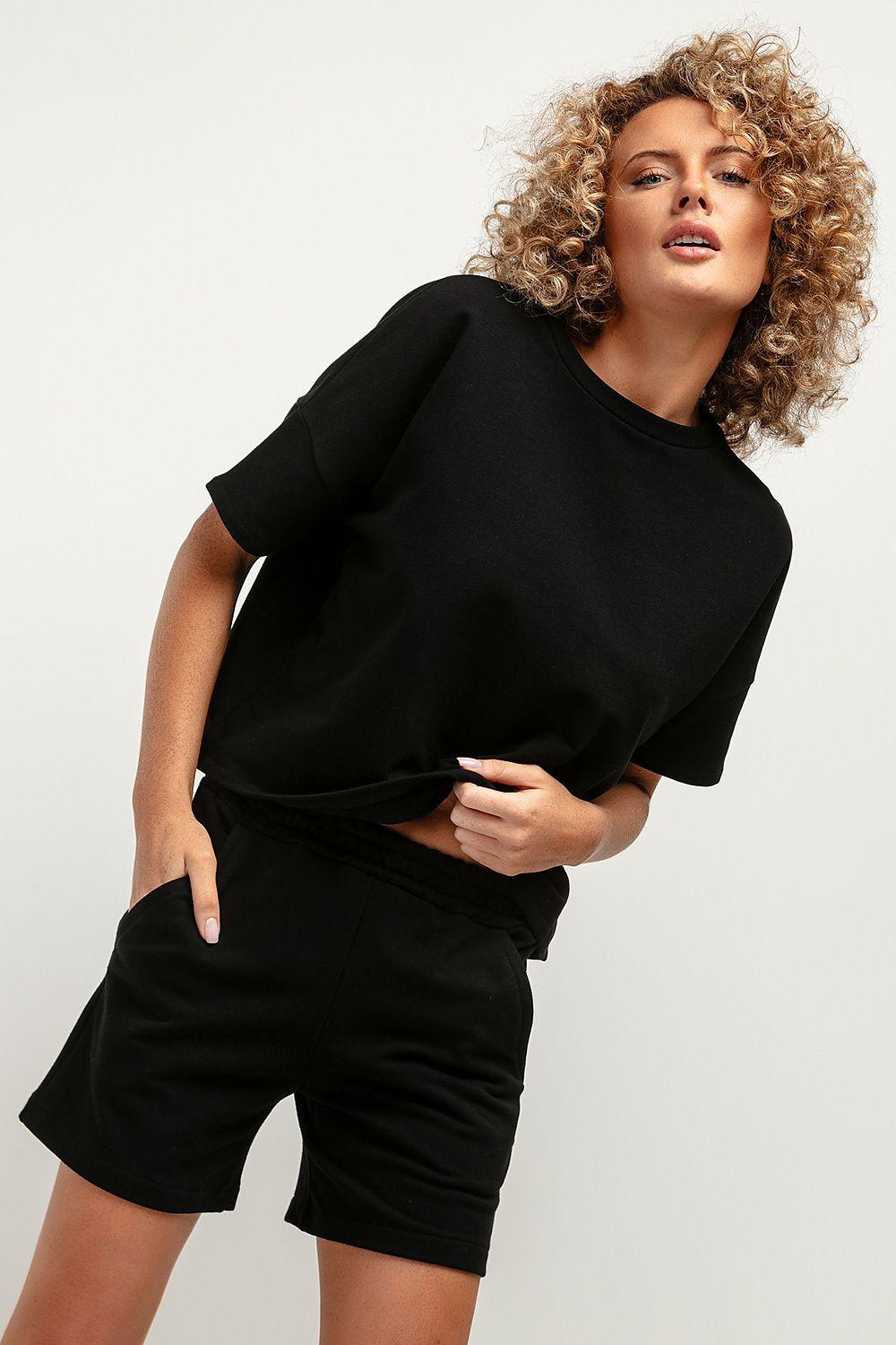 Black knit blouse with loose urban fit, short sleeves, and crew neck