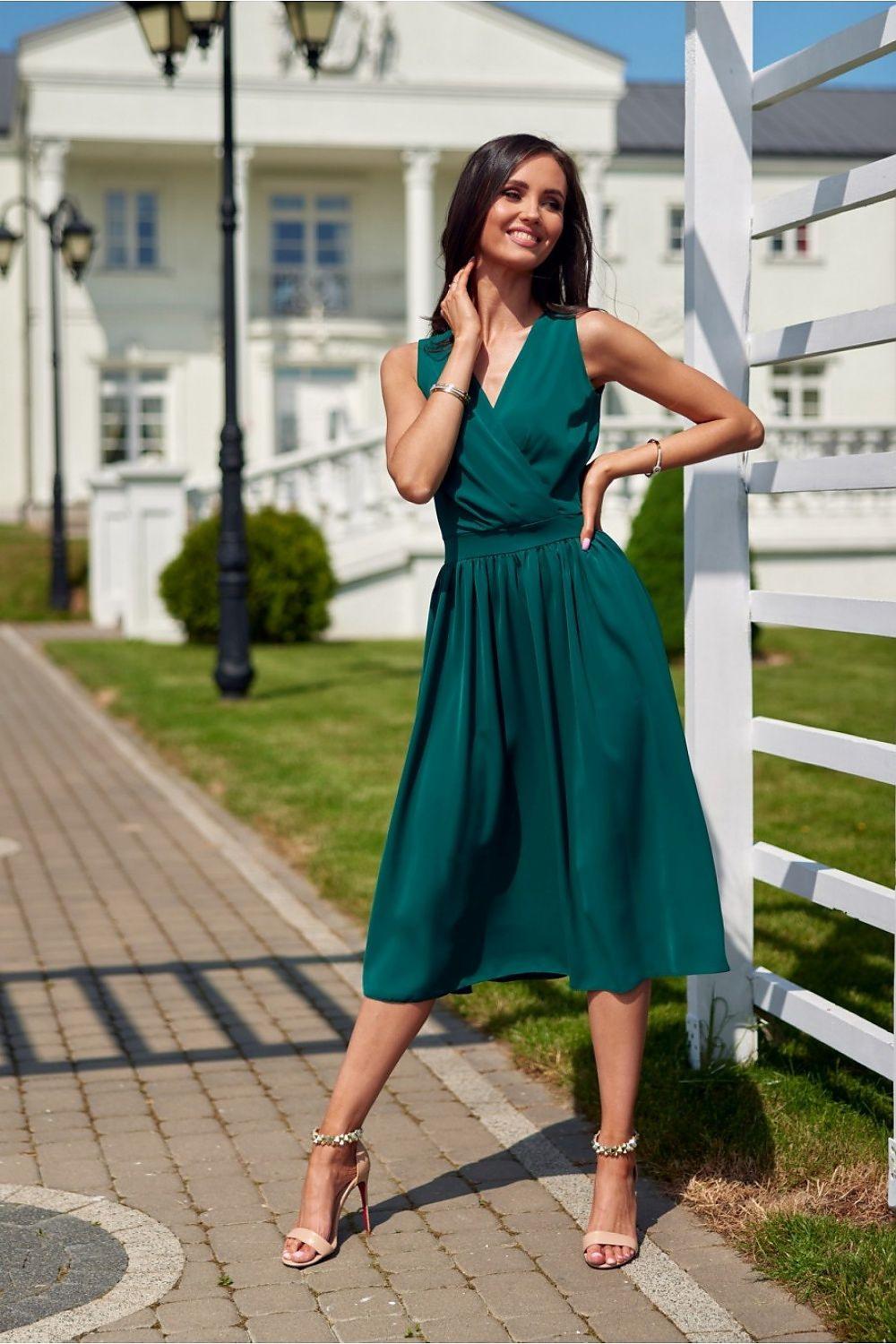 Green V-neck sleeveless midi cocktail dress, gathered waist and pleated skirt, side view