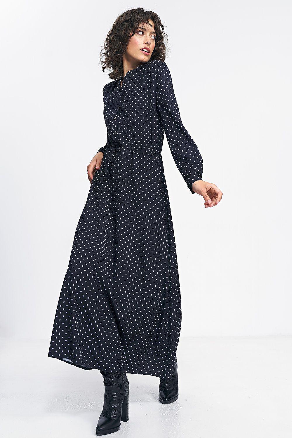 Black long-sleeve daydress with V-neck, waist tie, and small white dot print