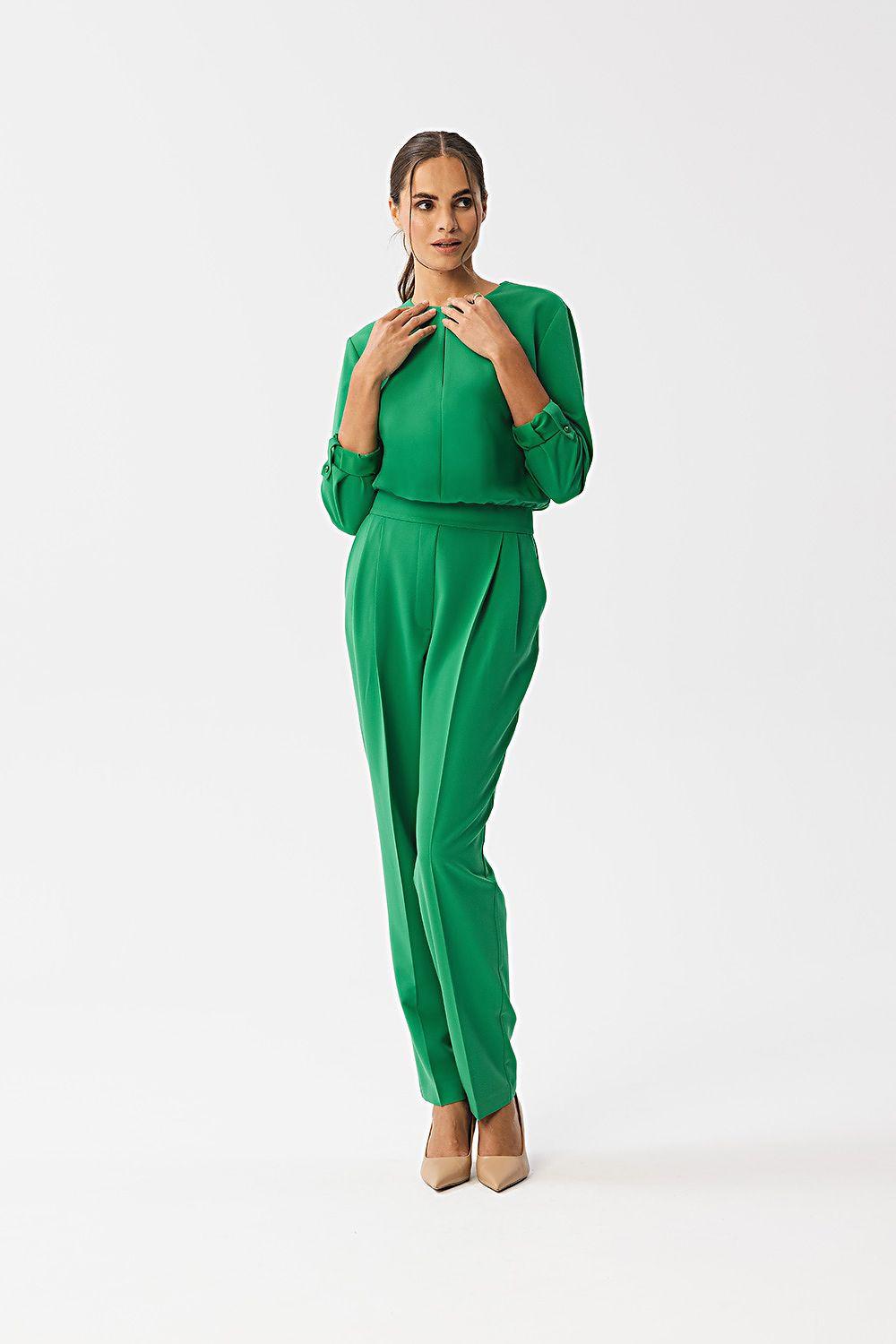 Green two-piece pantsuit with long sleeves and matching slim trousers