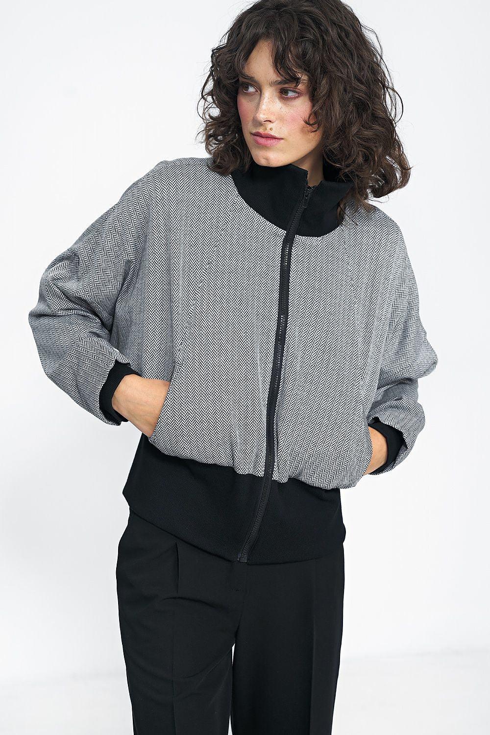 Short gray herringbone jacket, full-zip front with black stand collar cuffs